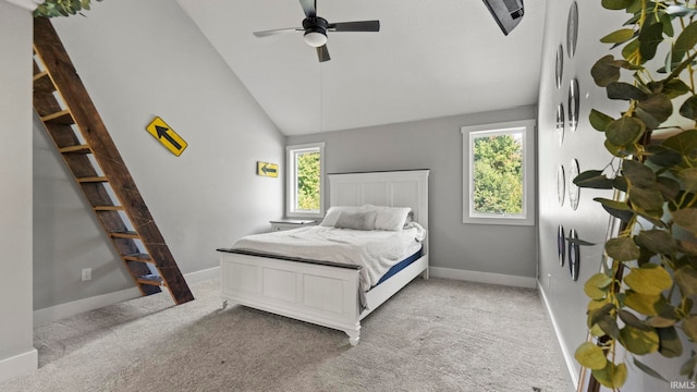 bedroom with ceiling fan, light carpet, multiple windows, and high vaulted ceiling