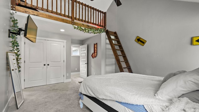 bedroom with light carpet, a closet, and ceiling fan