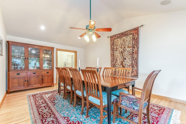 dining area featuring lofted ceiling, light hardwood / wood-style floors, and ceiling fan