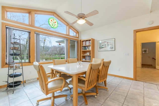 dining room featuring light tile patterned floors, vaulted ceiling, and ceiling fan