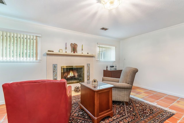 living room featuring ornamental molding, a fireplace, and tile patterned flooring