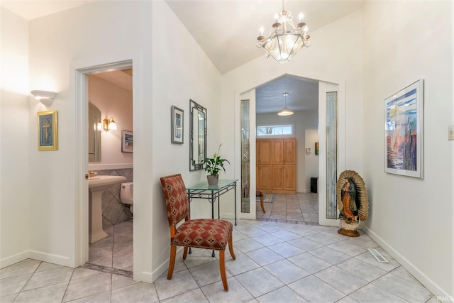 hall featuring a chandelier and light tile patterned flooring