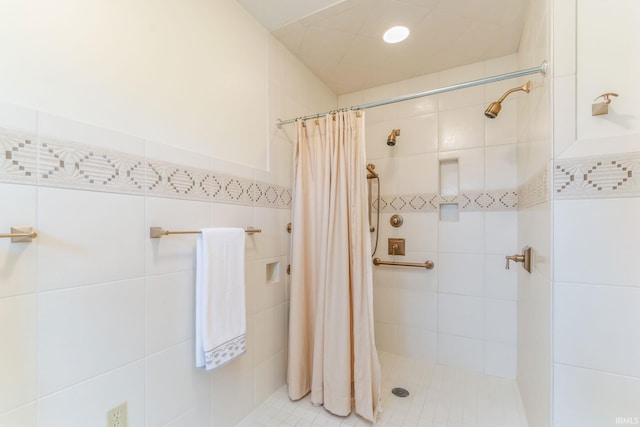 bathroom with tile walls and a shower with shower curtain