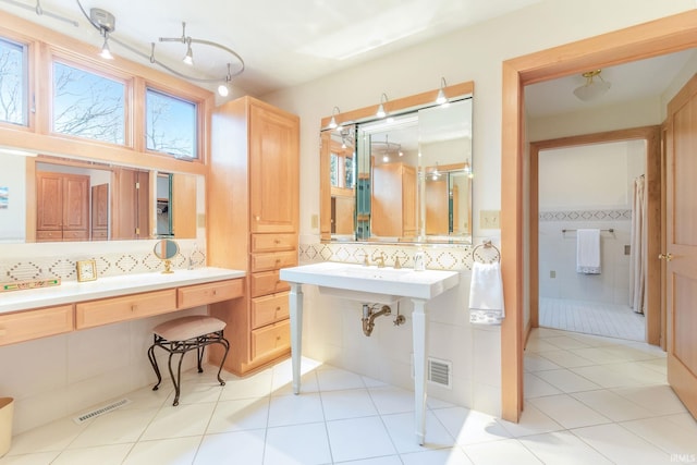 bathroom featuring tile walls, tile patterned flooring, and decorative backsplash