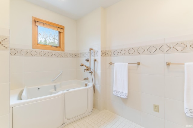 bathroom with tile walls and a bath