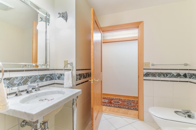 bathroom featuring tile walls, sink, tile patterned floors, and toilet