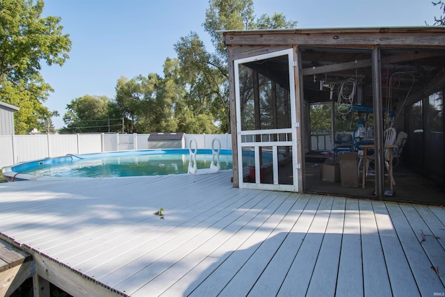 wooden terrace featuring a fenced in pool