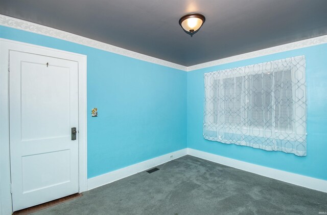 unfurnished living room with carpet floors, a fireplace, and ornamental molding