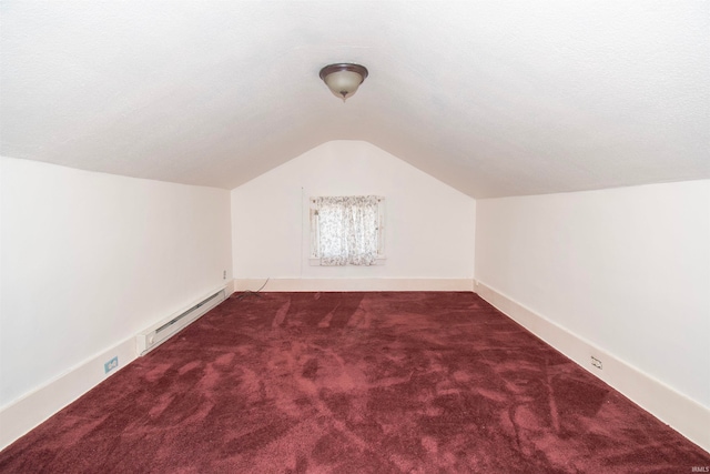 additional living space featuring a textured ceiling, lofted ceiling, carpet, and baseboard heating