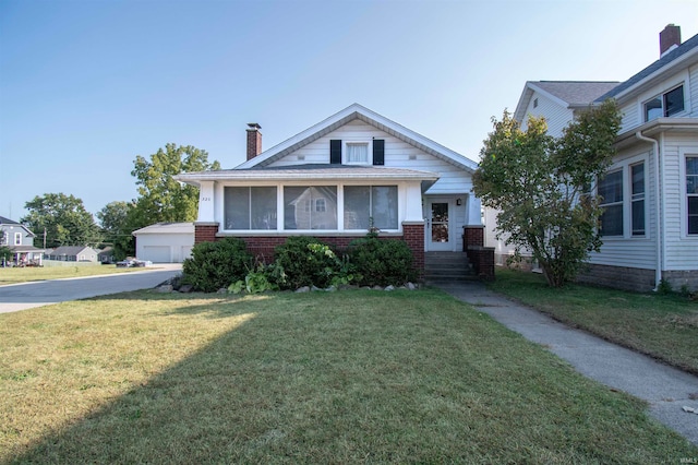 view of front of house featuring a garage and a front lawn