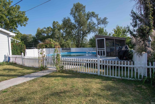 exterior space featuring a yard and a sunroom