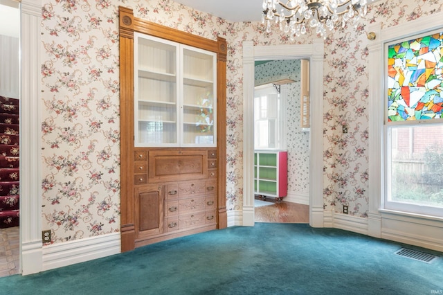 interior space with an inviting chandelier and carpet