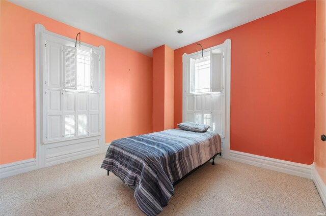 bedroom featuring multiple windows and carpet floors