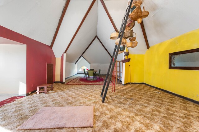 additional living space featuring carpet floors and vaulted ceiling with beams