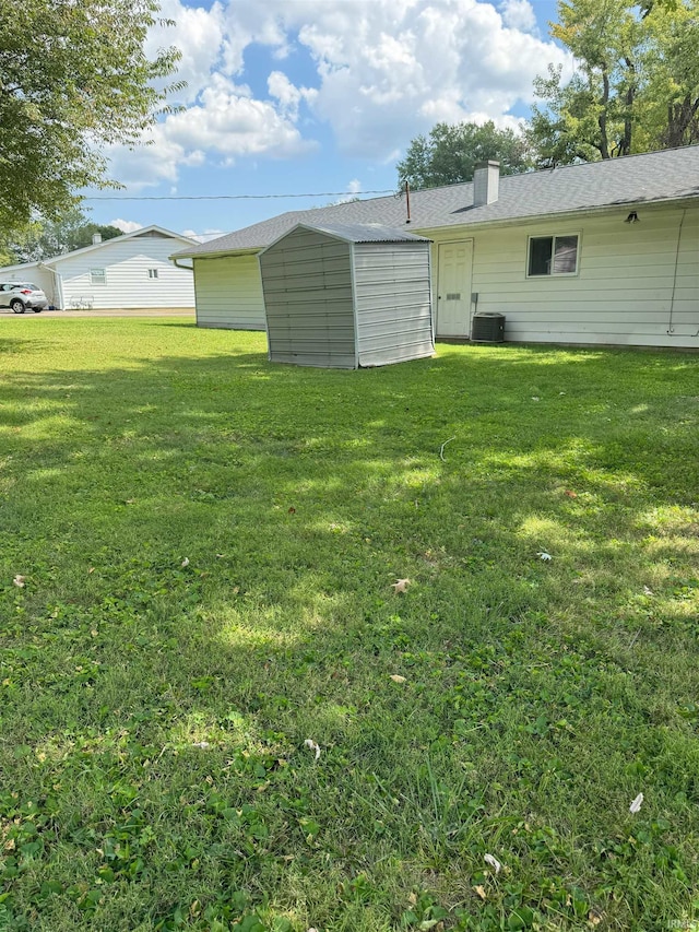 view of yard with a shed and central AC