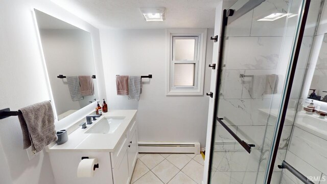 bathroom featuring walk in shower, vanity, a baseboard heating unit, and tile patterned floors