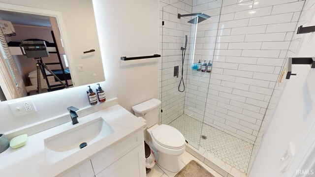 bathroom with vanity, tile patterned flooring, toilet, and an enclosed shower