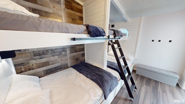 bathroom featuring a textured ceiling, toilet, vanity, and tiled shower