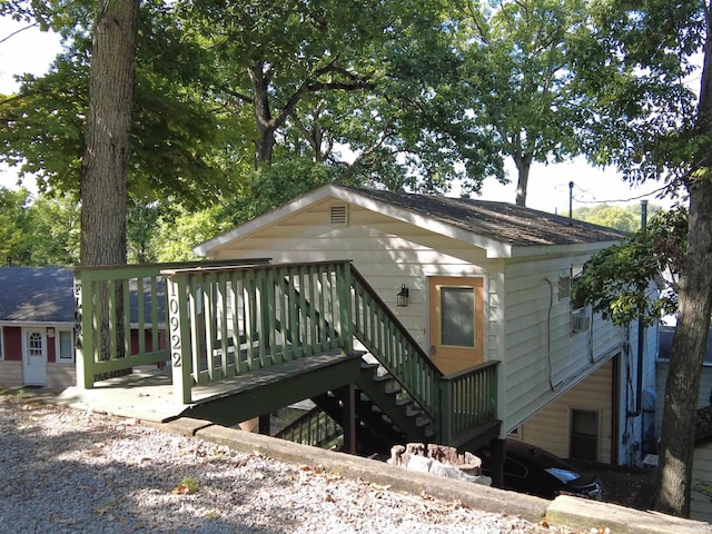 10922 N Lower Lakeshore Dr, Monticello, IN 47960 - rear view of property featuring a shingled roof and a wooden deck