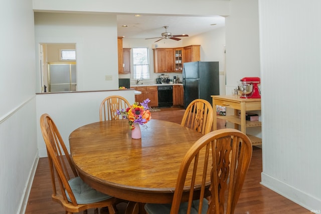 dining space with ceiling fan, dark hardwood / wood-style floors, and sink