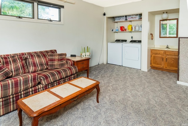 living room with light carpet and washer and dryer