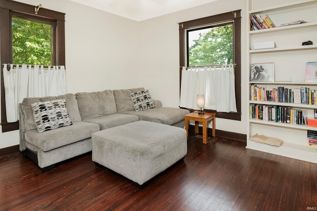 living room featuring plenty of natural light and dark hardwood / wood-style flooring