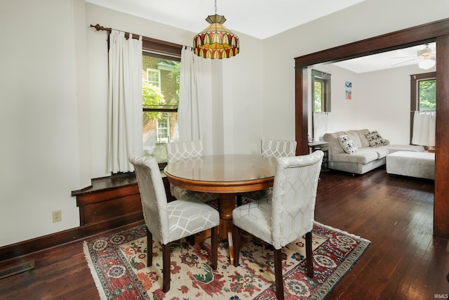 dining space featuring a healthy amount of sunlight, dark hardwood / wood-style floors, and ceiling fan