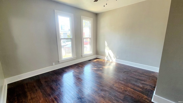 unfurnished room with ceiling fan and dark hardwood / wood-style flooring