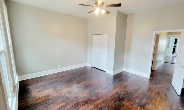 unfurnished room featuring ceiling fan and dark hardwood / wood-style floors