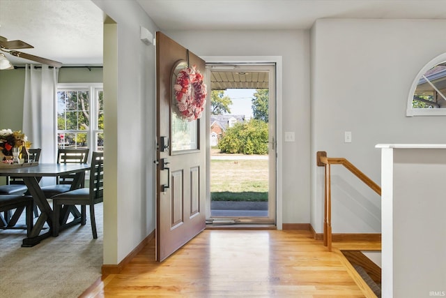 entryway with ceiling fan and light hardwood / wood-style floors