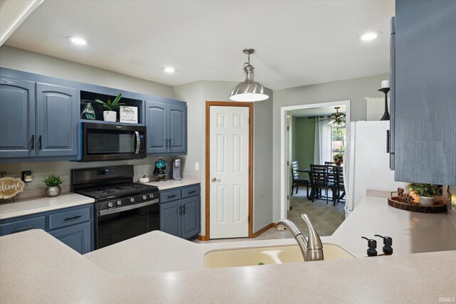 kitchen with blue cabinetry, decorative light fixtures, and black range with gas stovetop