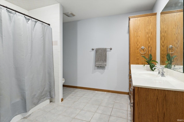 bathroom with a shower with shower curtain, tile patterned floors, vanity, and toilet