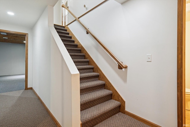 stairs featuring carpet