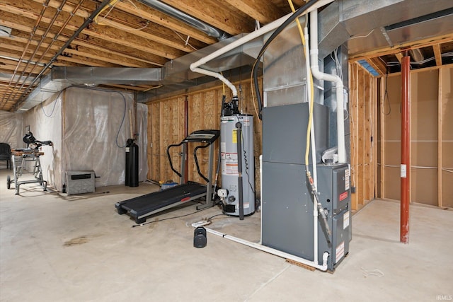 basement featuring heating unit and water heater