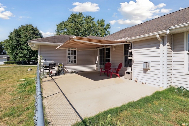 back of house with a yard and a patio area