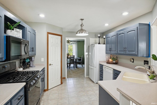 kitchen featuring light tile patterned flooring, stainless steel appliances, ceiling fan, decorative light fixtures, and sink