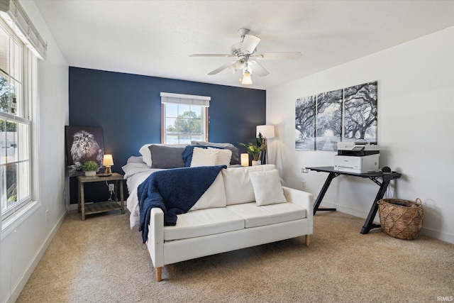 bedroom with ceiling fan and light colored carpet