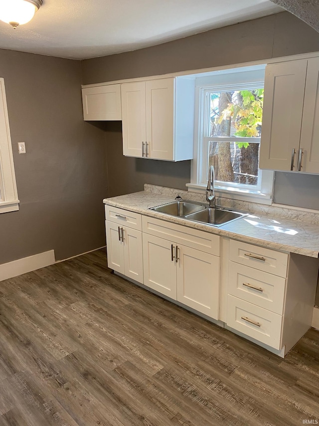 1243 Portage Ave, South Bend, IN 46616 - kitchen featuring a sink, light countertops, white cabinetry, and dark wood-style flooring