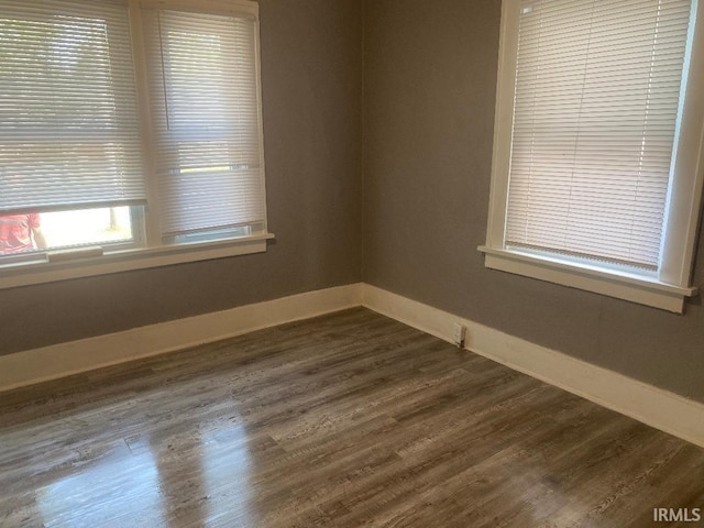 spare room featuring dark hardwood / wood-style flooring