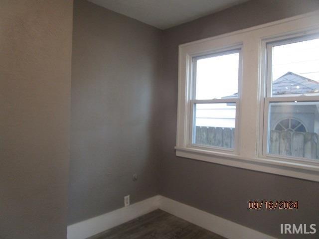 1243 Portage Ave, South Bend, IN 46616 - empty room with dark wood-type flooring and baseboards
