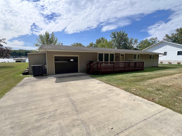 single story home with a front yard, a deck, and a garage