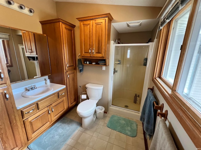 bathroom featuring vanity, vaulted ceiling, a shower with shower door, and toilet