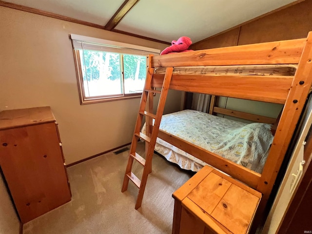 carpeted bedroom with lofted ceiling