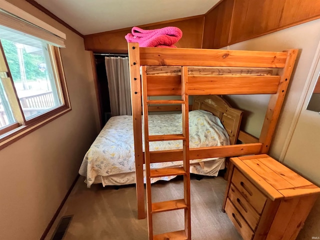 carpeted bedroom featuring lofted ceiling and crown molding