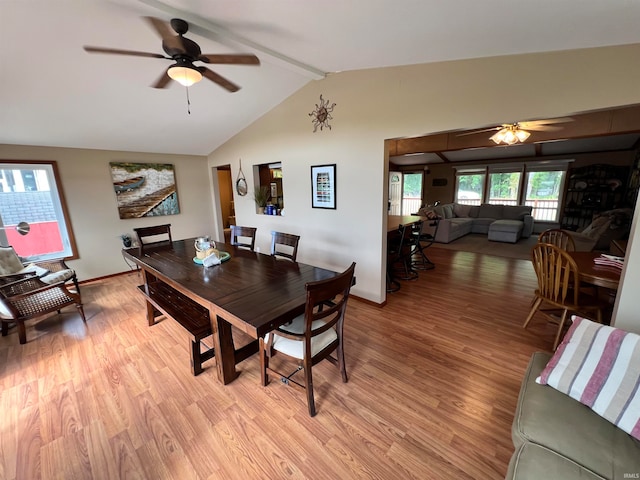 dining room featuring light hardwood / wood-style flooring, ceiling fan, and lofted ceiling with beams