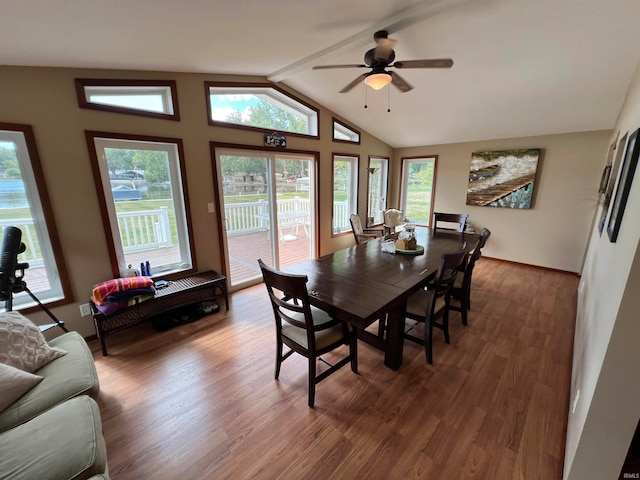 dining room featuring vaulted ceiling with beams, ceiling fan, plenty of natural light, and dark hardwood / wood-style flooring