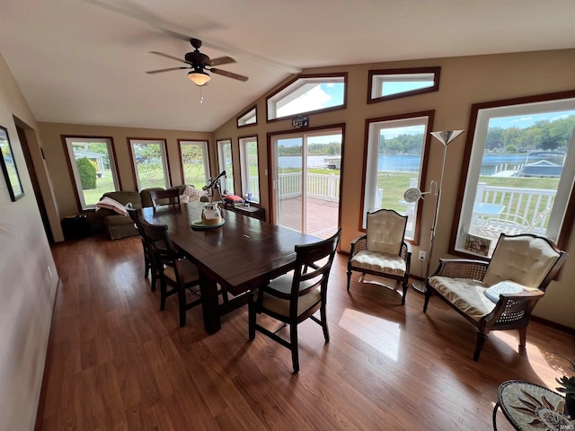 dining room featuring vaulted ceiling, ceiling fan, and dark wood-type flooring