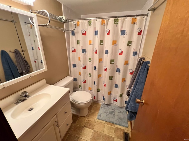 bathroom featuring vanity, toilet, and a shower with curtain