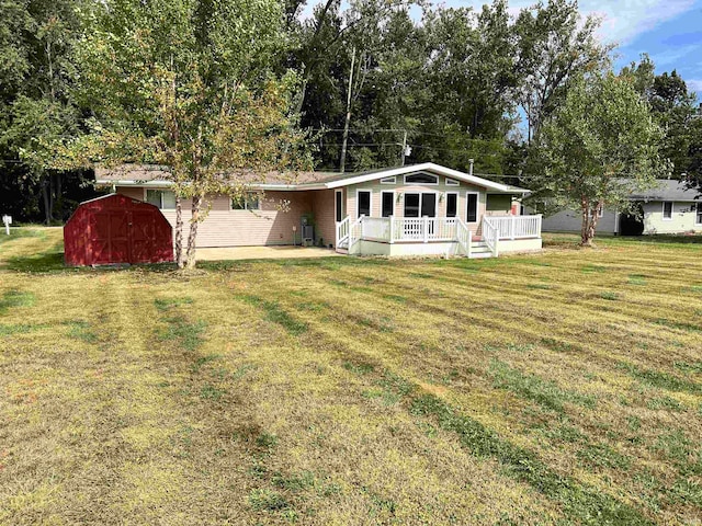 view of front of property with a front yard, a porch, and a storage unit