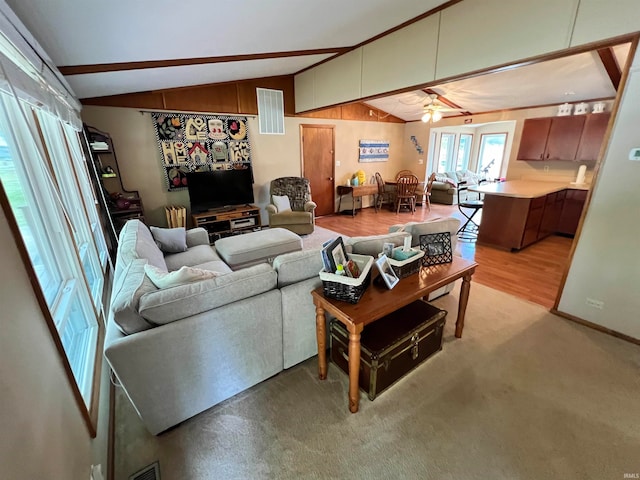 living room featuring ceiling fan, lofted ceiling, and light hardwood / wood-style floors